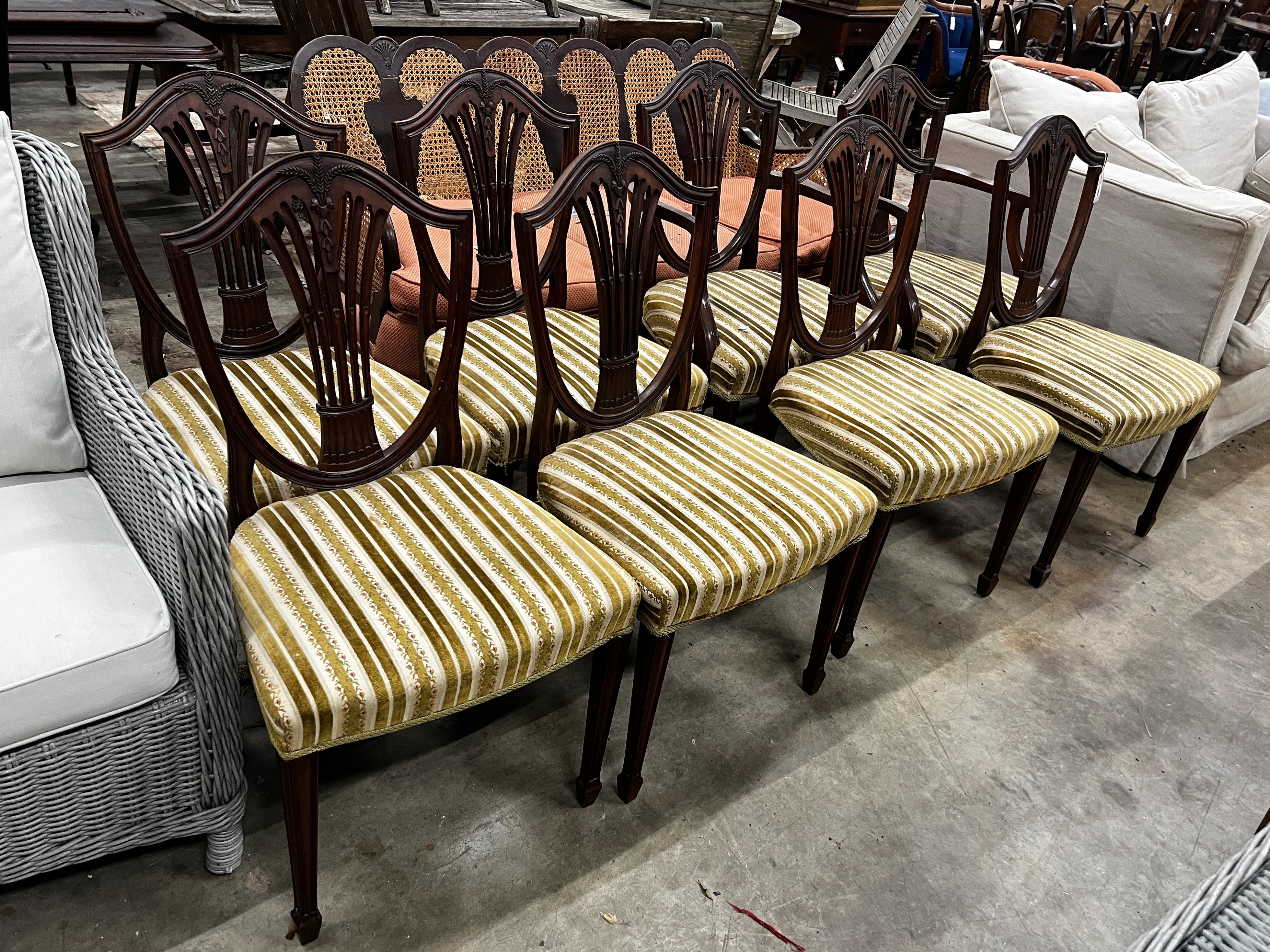 A set of eight early 20th century mahogany Hepplewhite style shield back dining chairs, two with arms